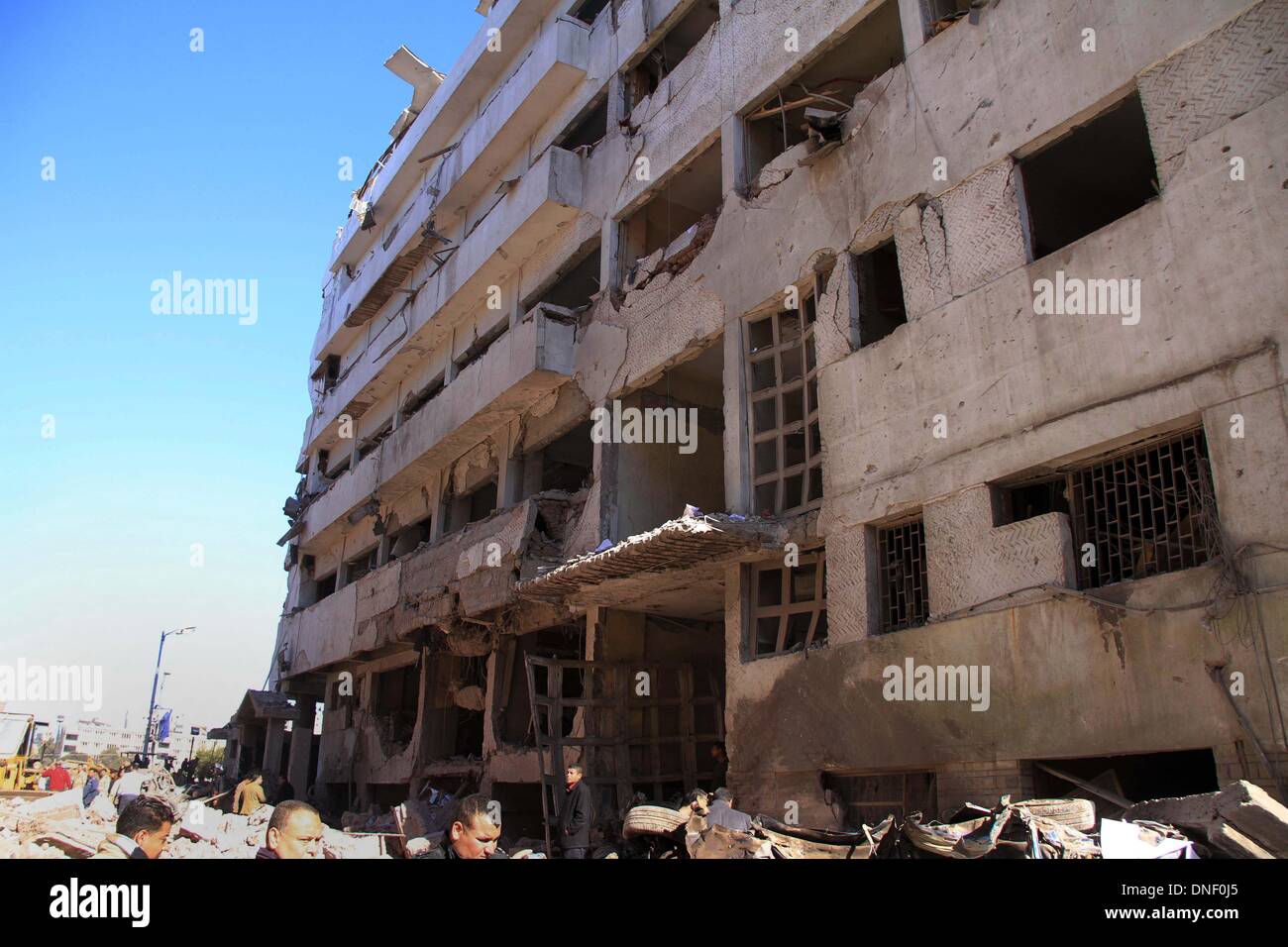 Mansura, Cairo, Egypt. 24th Dec, 2013. Egyptians inspect destruction in the Egyptian city of Mansura, North of Cairo, following a powerful car bomb explosion on December 24, 2013. The bombing tore through a police building in Mansura early today, killing at least 14 people, an attack the authorities said was aimed at derailing the country's transition to democracy © Mohammed Bendari/APA Images/ZUMAPRESS.com/Alamy Live News © ZUMA Press, Inc. Credit:  ZUMA Press, Inc./Alamy Live News Stock Photo