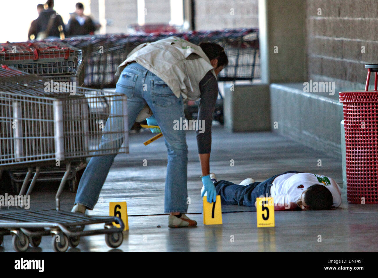 Investigators number the bullet casings found at the scene of a drug related execution at the Costco Store January 15, 2009 in Juarez, Mexico. The shooting, believed linked to the ongoing drug war which has already claimed more than 40 people since the start of the year. More than 1600 people were killed in Juarez in 2008, making Juarez the most violent city in Mexico. Stock Photo