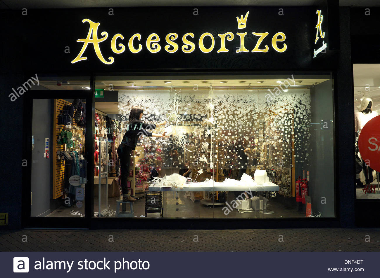 A shop  worker removes Christmas  decorations  in the display 