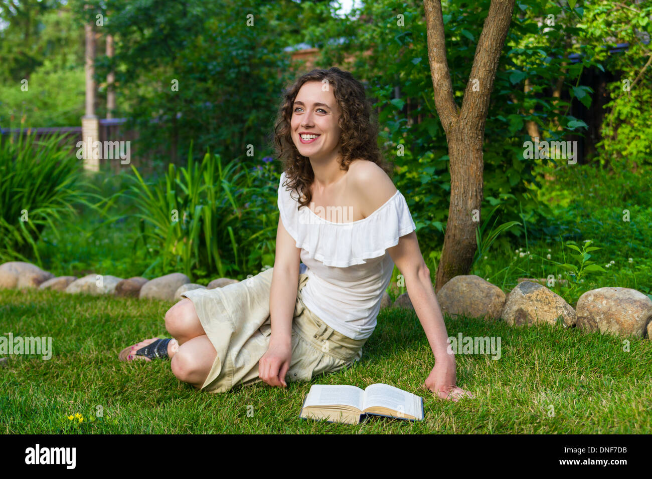 Beautiful romantic woman with book outdoors Stock Photo
