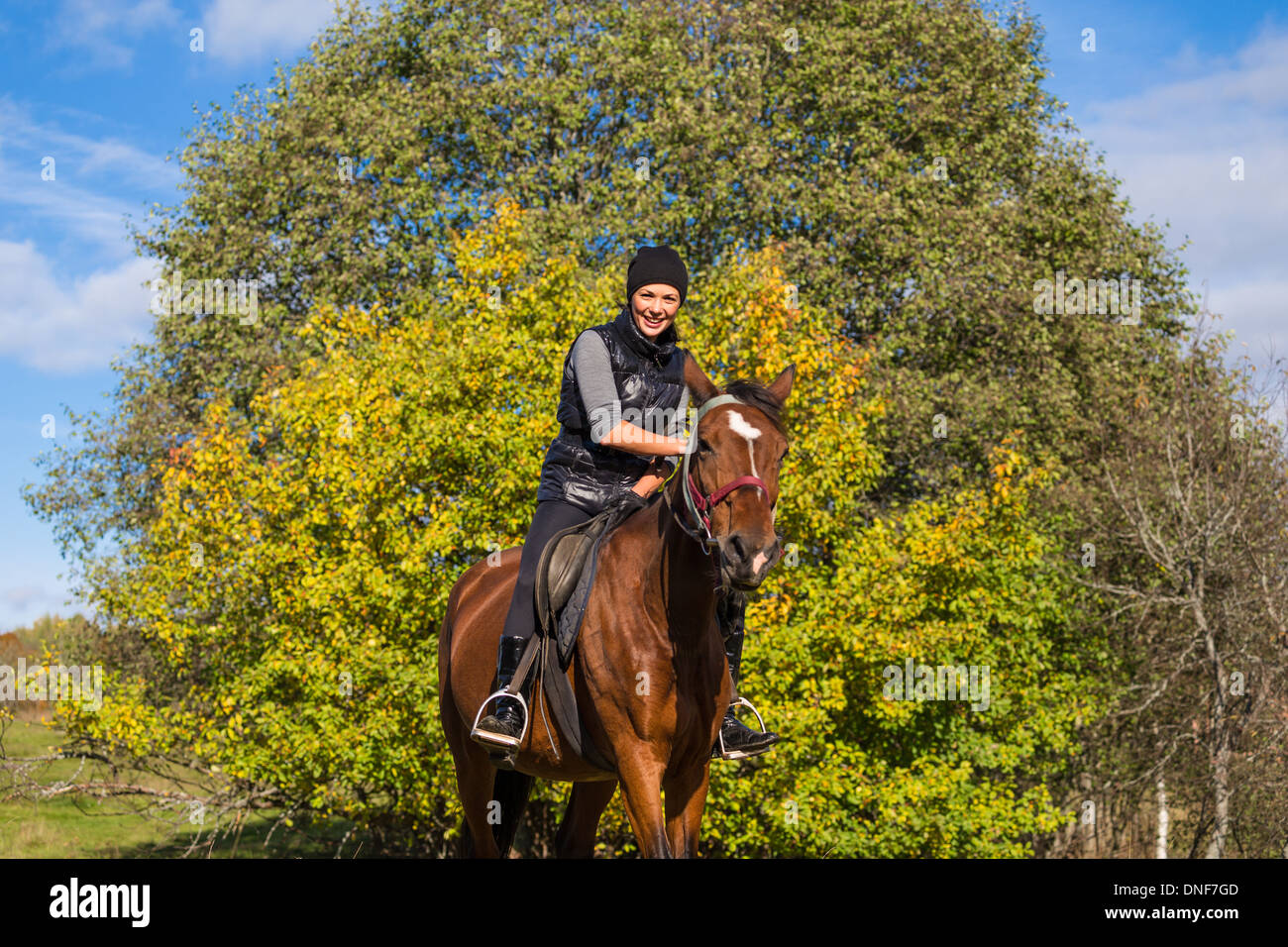 Elegant young woman riding horse Stock Photo