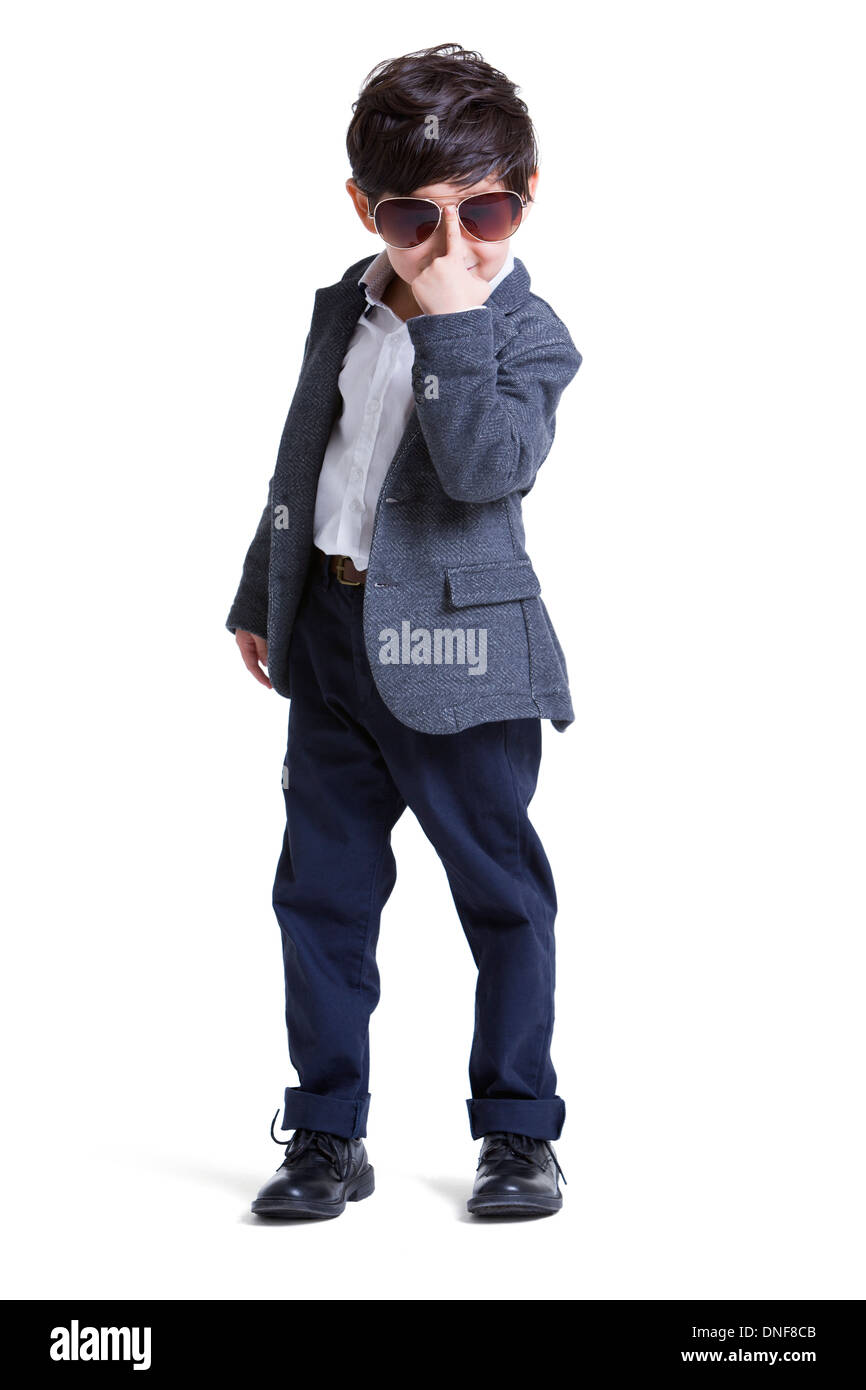 Trendy little boy adjusting sunglasses Stock Photo