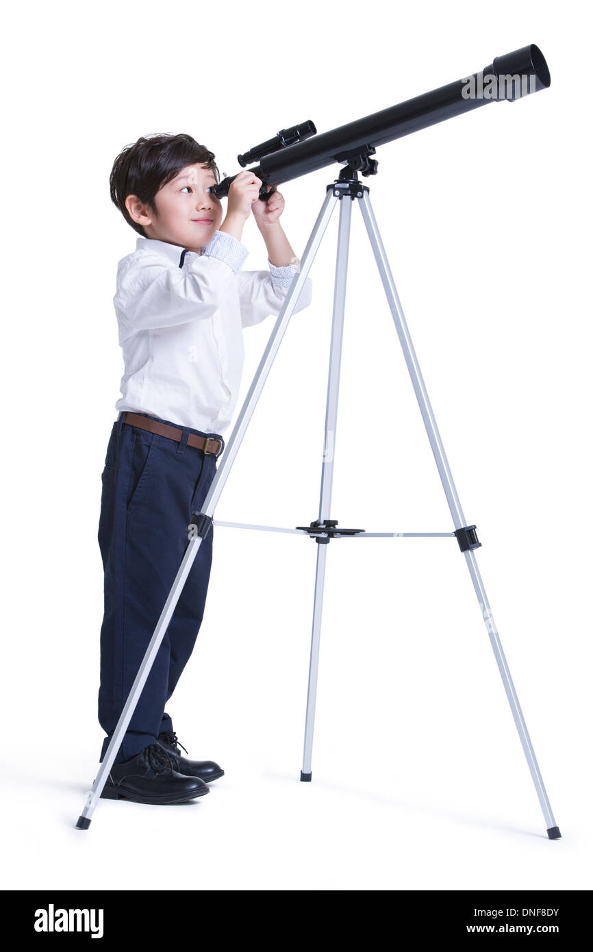 Cute boy looking through an astronomical telescope Stock Photo Alamy