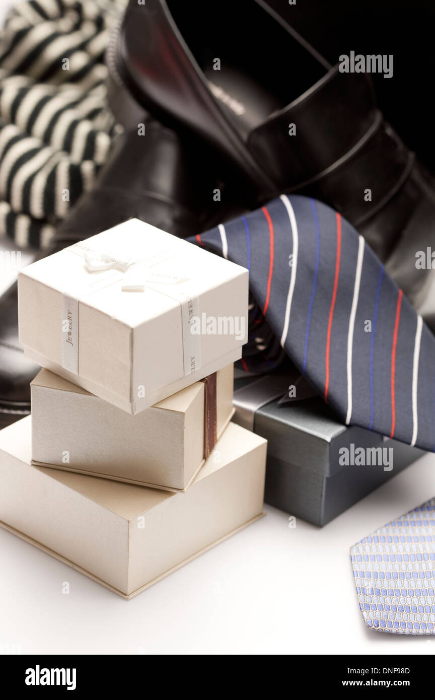 Pile of gift boxes with ties and leather shoes in the background Stock Photo