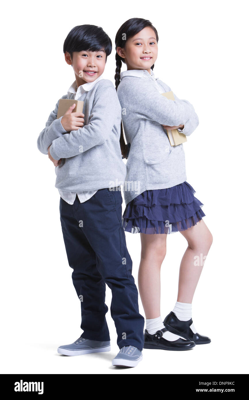 Cheerful schoolgirl and schoolboy back to back Stock Photo - Alamy