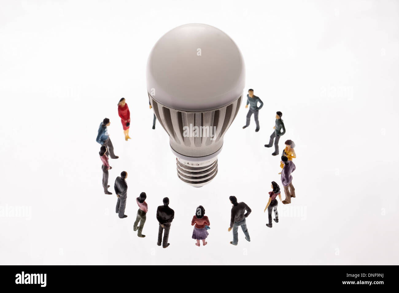 Light bulb surrounded by figurines Stock Photo Alamy