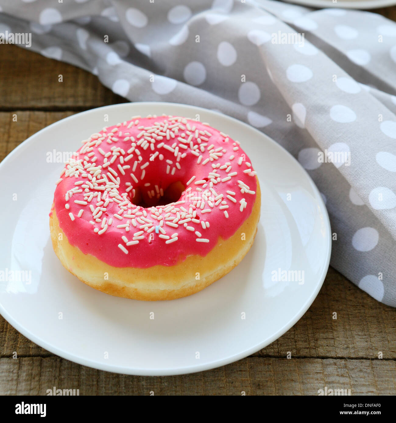 round donut with pink icing, food closeup Stock Photo