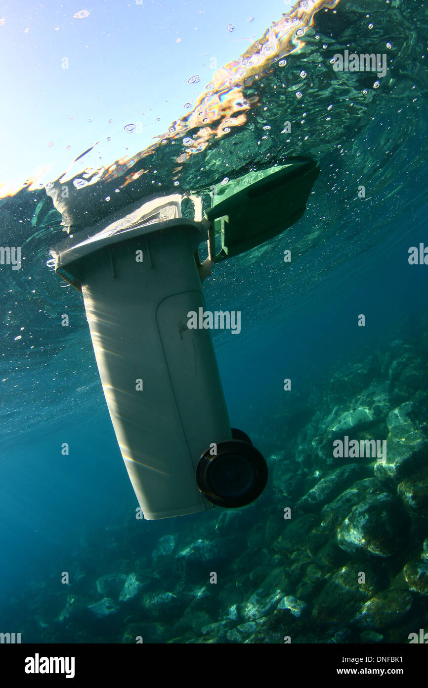 Pollution at sea, bin floating in the sea Stock Photo