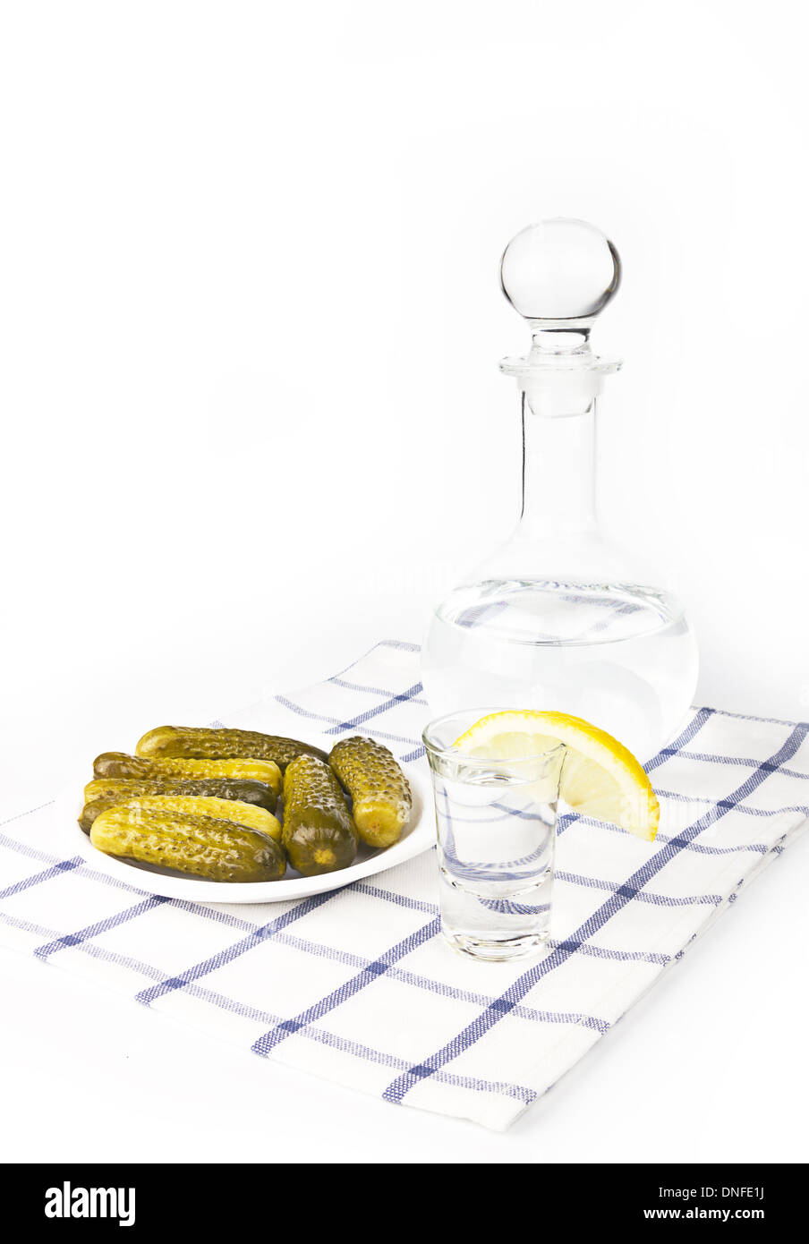 Russian vodka with lemon and salty cucumbers Stock Photo