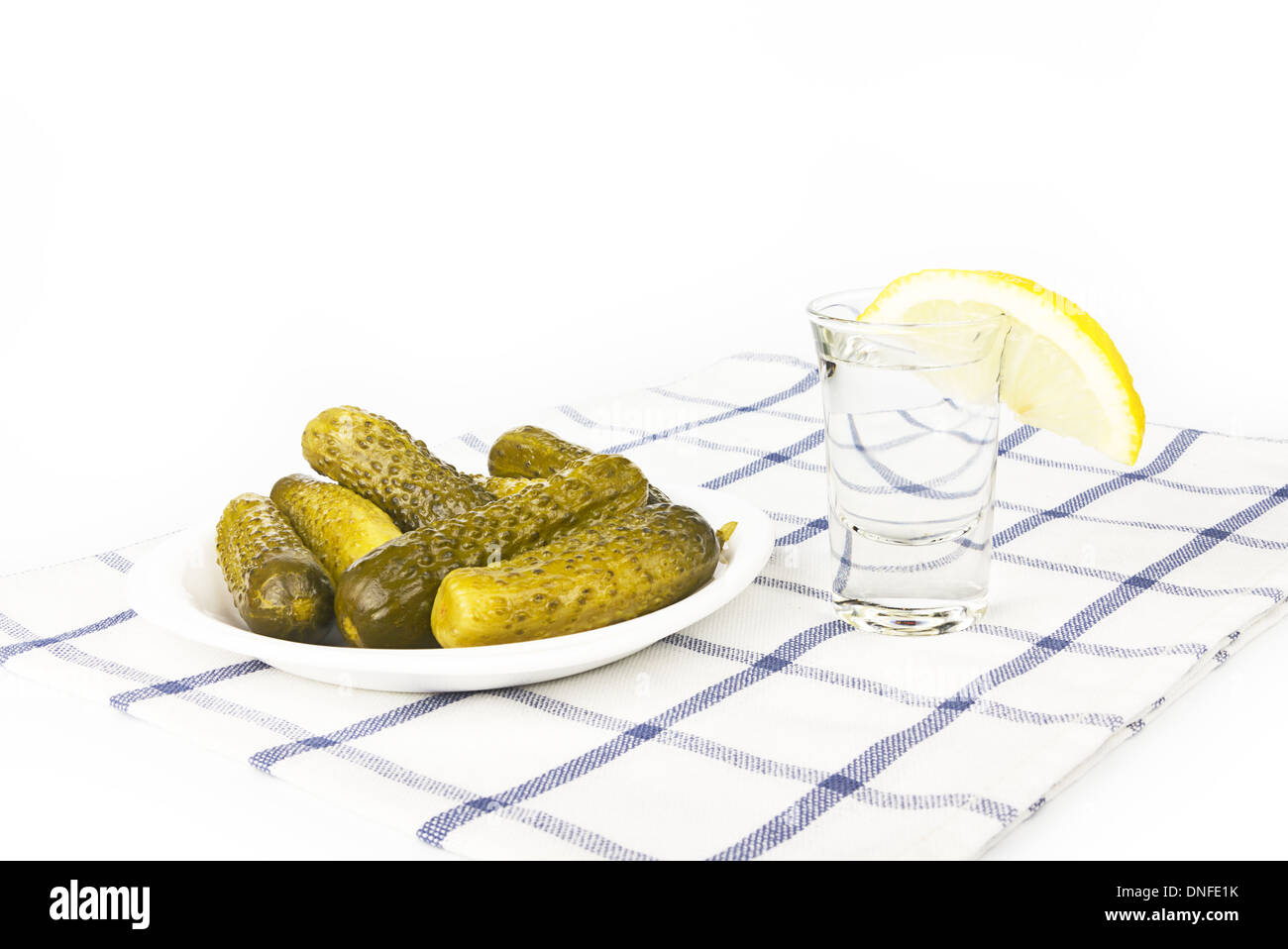 Russian vodka with lemon and salty cucumbers Stock Photo