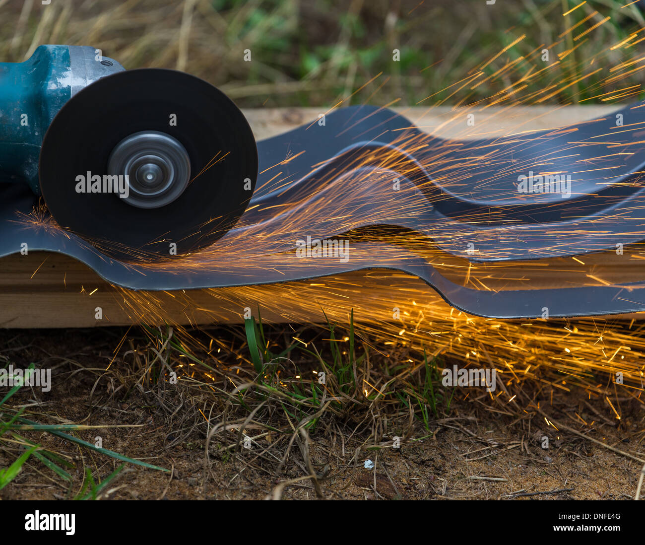 sharpening and cutting of iron by abrasive disk machine Stock Photo - Alamy