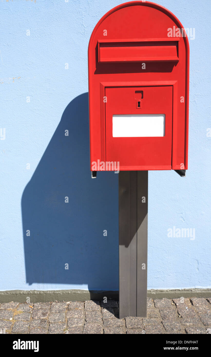 red post box or mailbox postbox letterbox on the street Stock Photo Alamy
