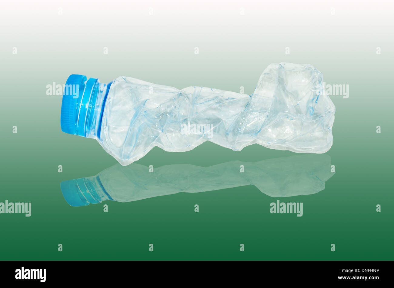 empty used plastic bottles on green background Stock Photo