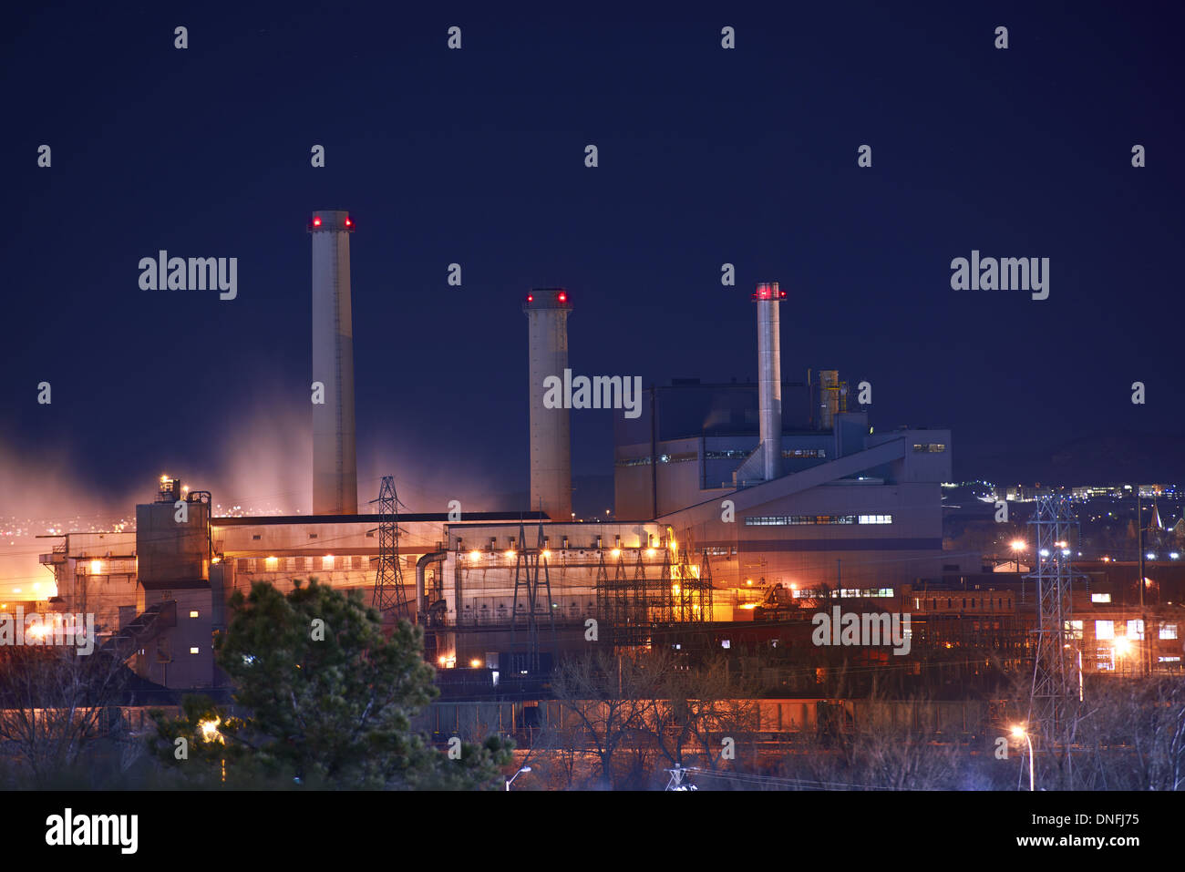 Industrial Zone at Night. Industrial Buildings Illumination and Smoke