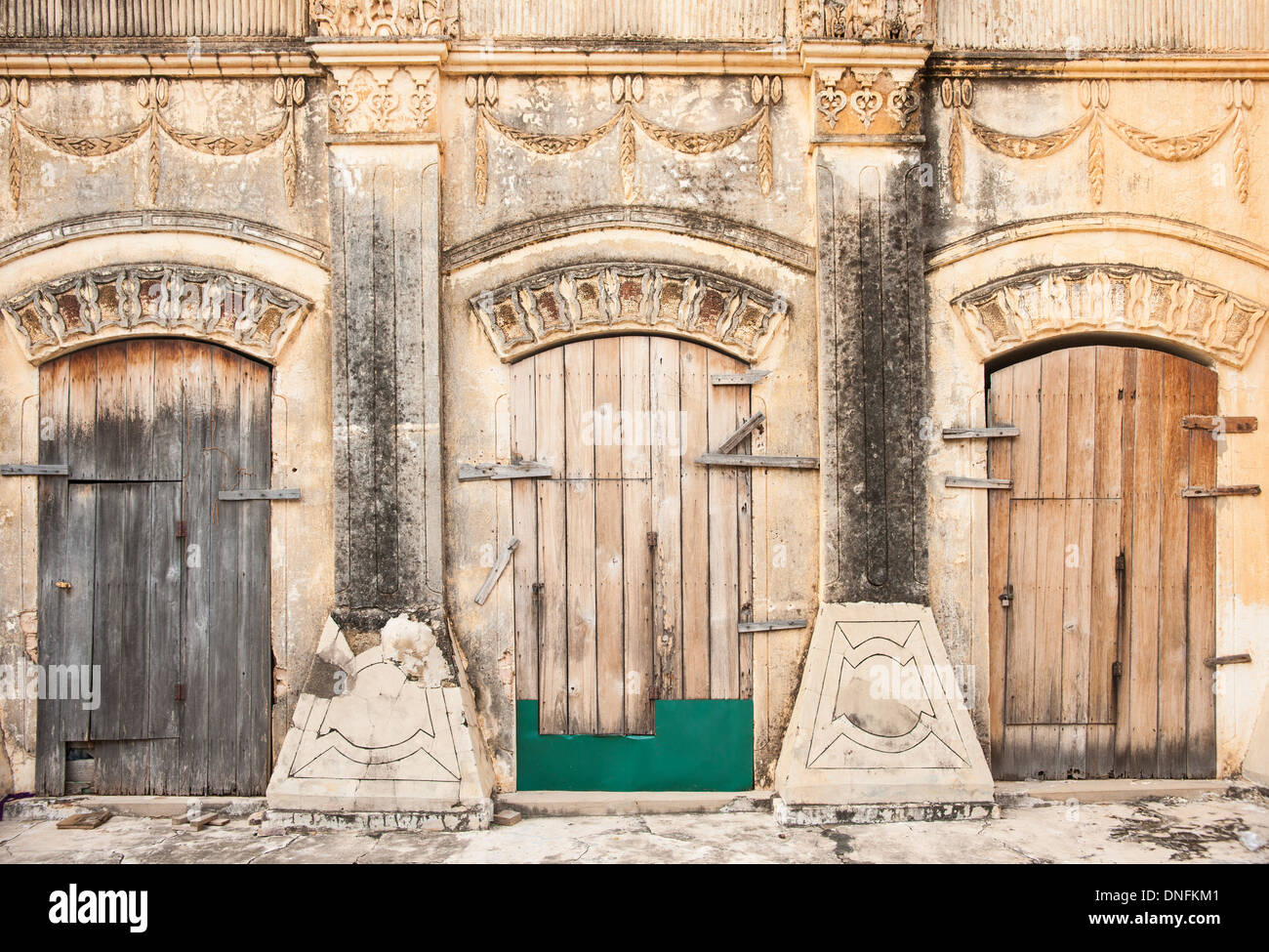 Three wooden doors in stone wall at a Burmese pagoda.Myanmar travel and people images Stock
