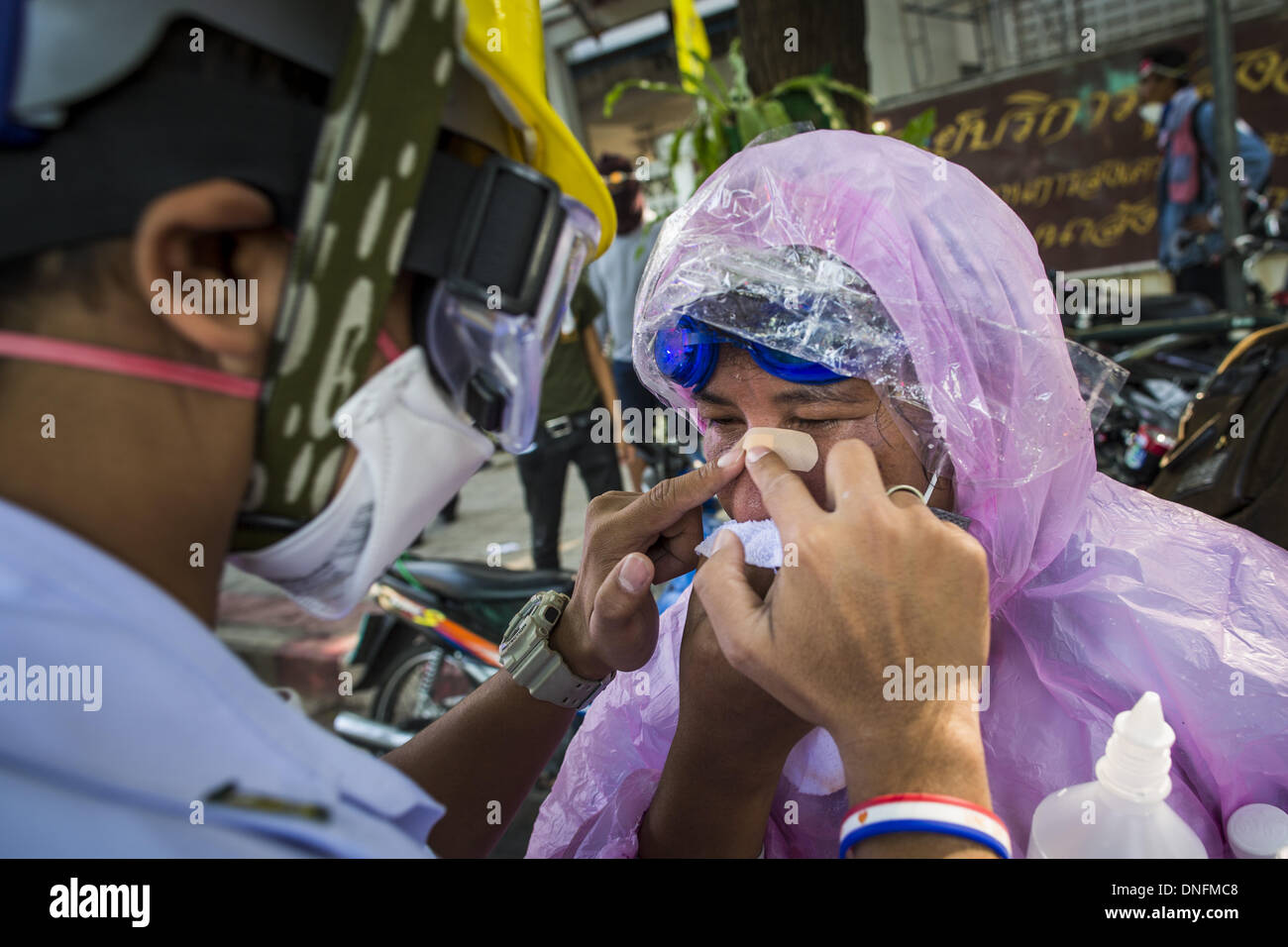 Bangkok, Thailand. 26th Dec, 2013. A medic help a woman who was injured ...