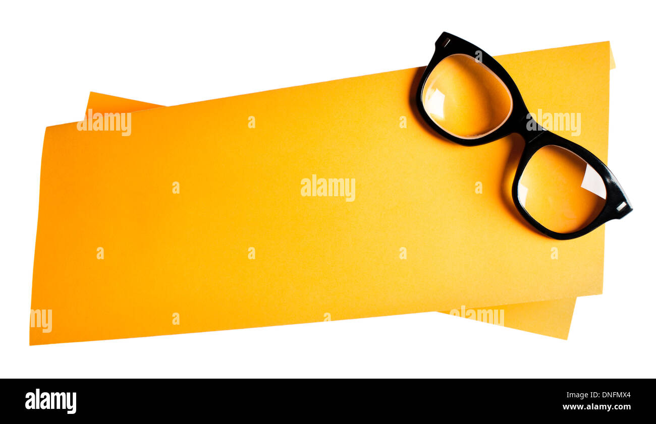 Vintage black framed eyeglasses on orange creative support Stock Photo