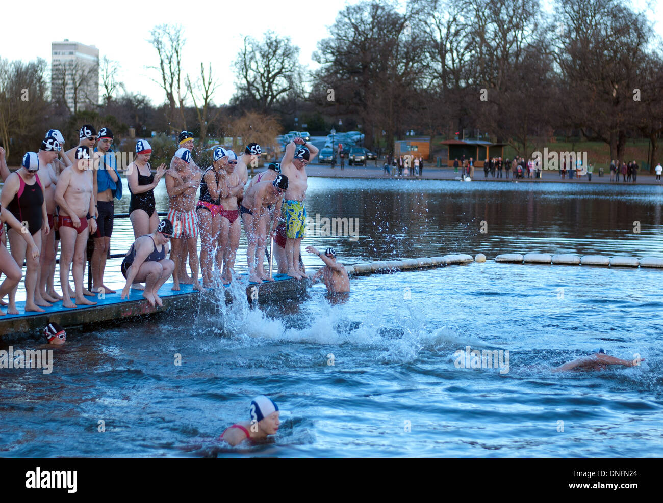 Members of the Serpentine Swimming Club making a splash in the icy Serpentine waters during the annual Christmas Day swim Stock Photo