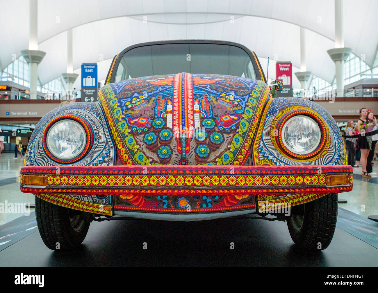 Vochol, Volkswagon Beetle, decorated by Huichol people of Mexico, with yarn paintings and beadwork, Denver International Airport Stock Photo