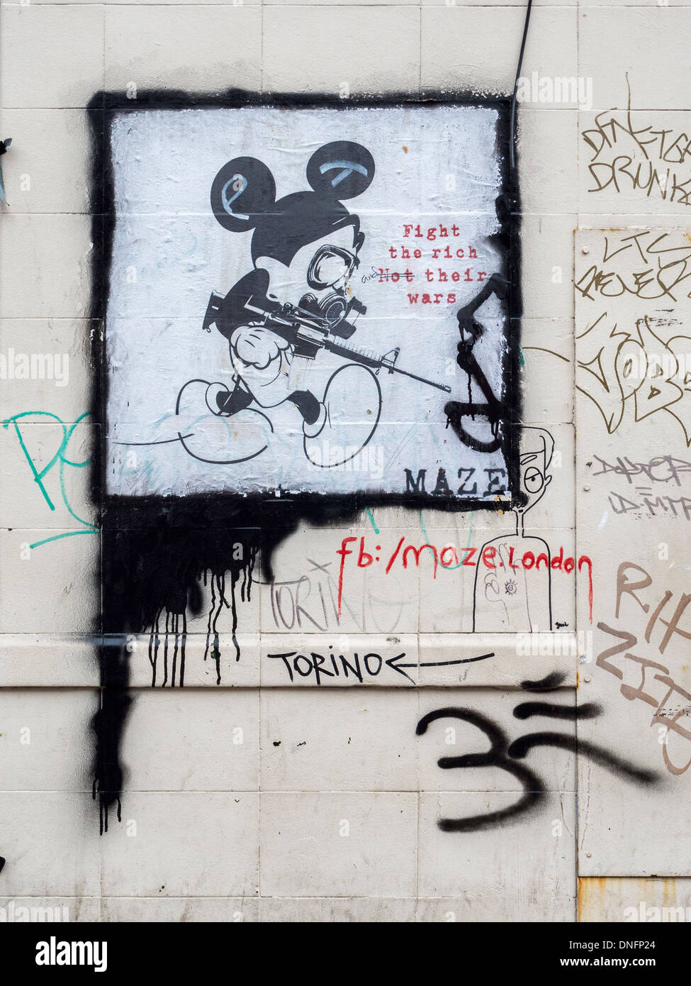 Poster street art - Mickey Mouse with gun and 'Fight the rich not their wars' slogan by MAZE - Brick Lane, London E1 Stock Photo