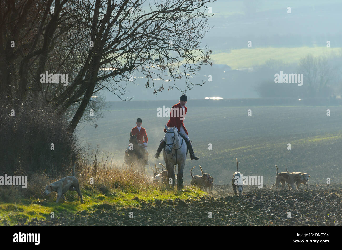 Oakham, Rutland, UK. 26th Dec, 2013. Huntsman Andrew Osborne and Whipper-In robert Medcalf leading the hounds after the Cottesmore Hunt's traditional Boxing Day meet. Credit:  Nico Morgan/Alamy Live News Stock Photo
