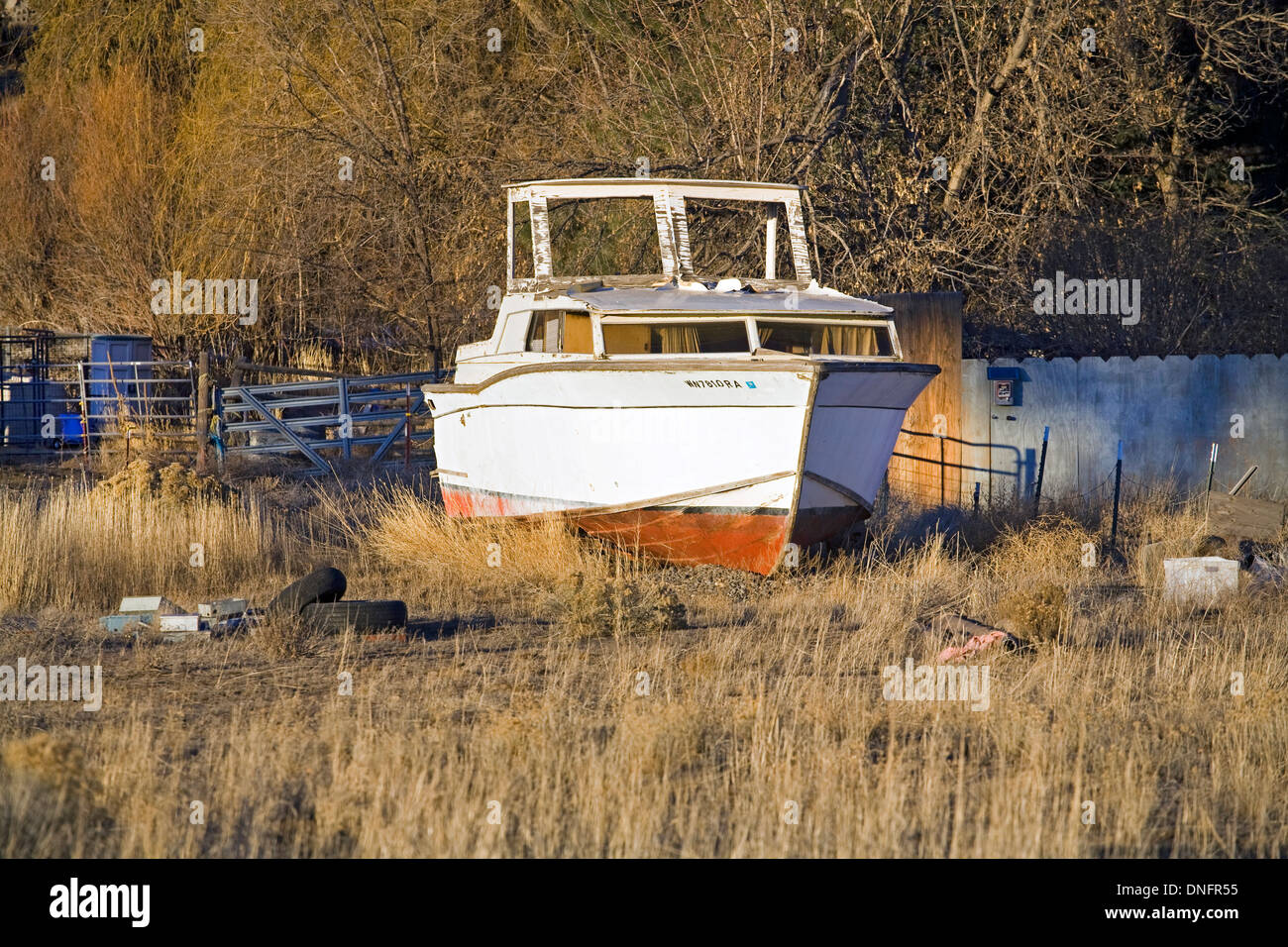 A badly neglected yacht sits in a field in central Oregon. Stock Photo