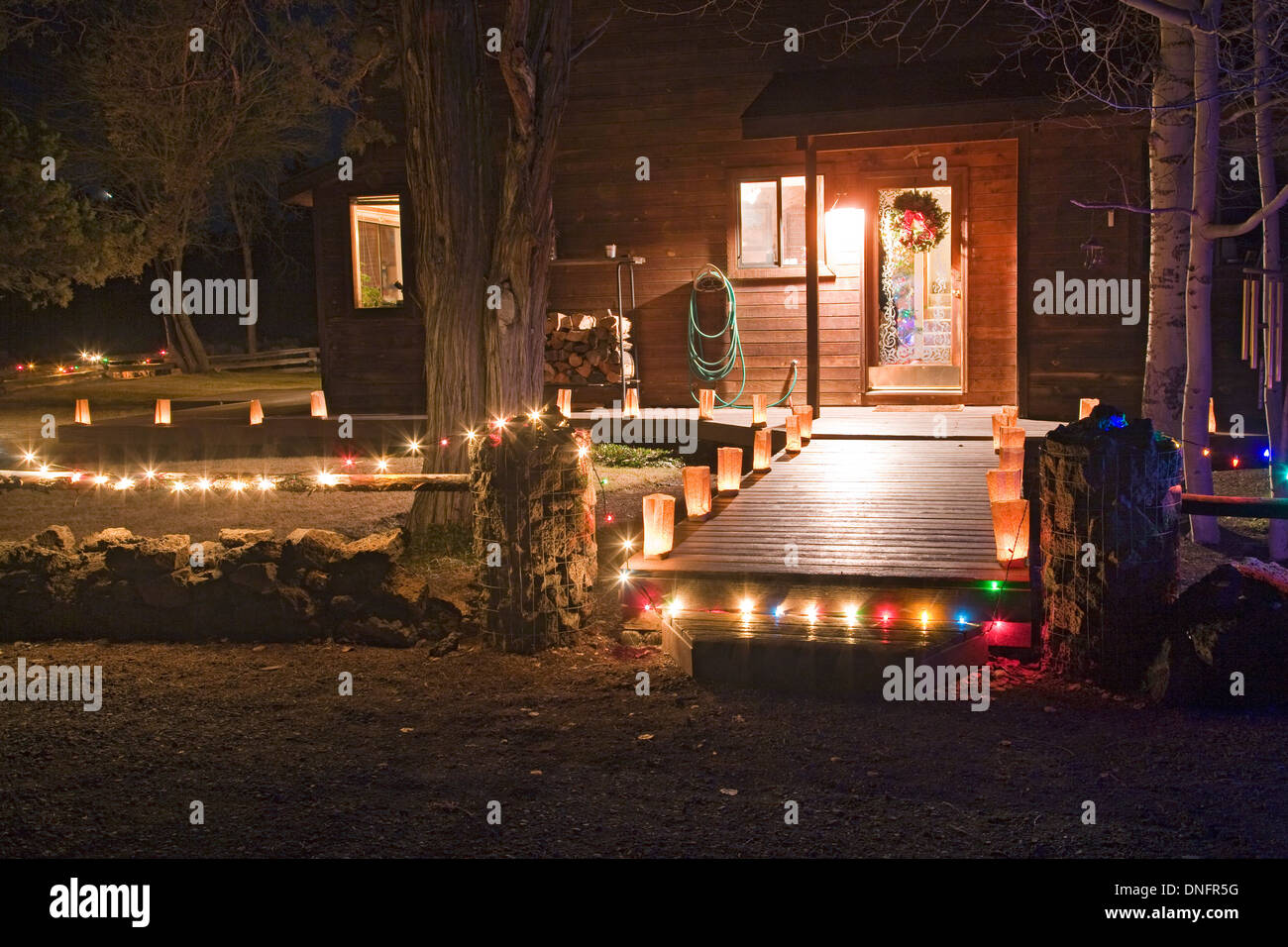 Christmas lights and New Mexican farolitos around the front deck of a house on Christmas Eve. Stock Photo