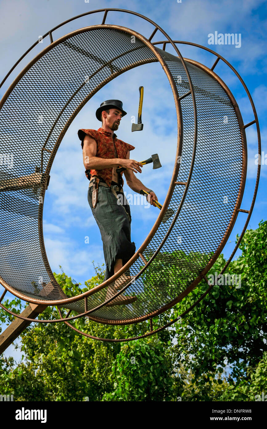 Circus performer entertaining the public with his hamster wheel Stock Photo