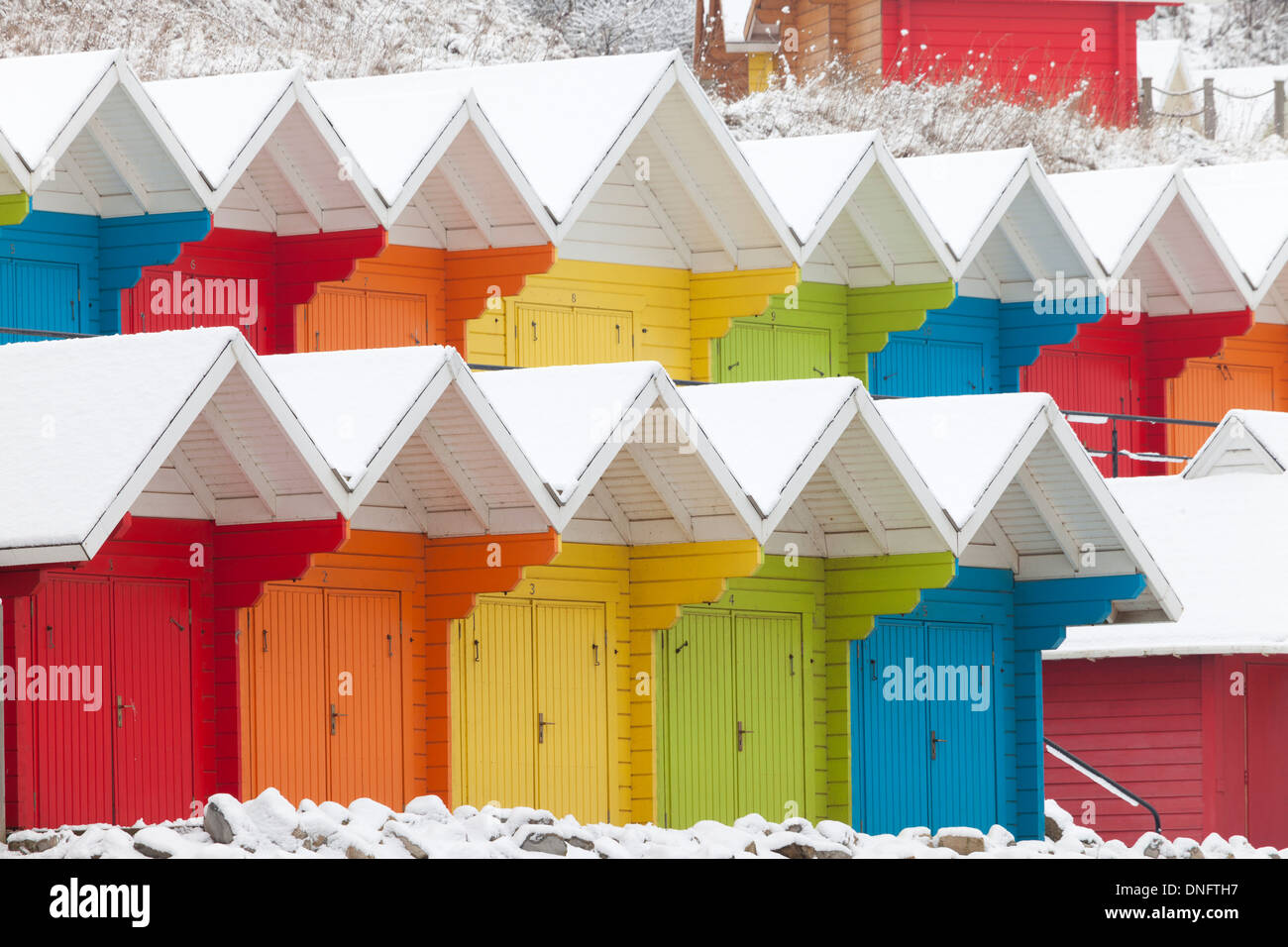 Colourful beach huts under heavy snow, in the north Bay, Scarborough, on the Yorkshire coast. Stock Photo