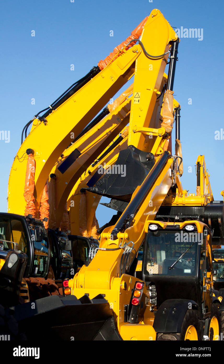 I line of brand new earth moving equipment in a row Stock Photo Alamy