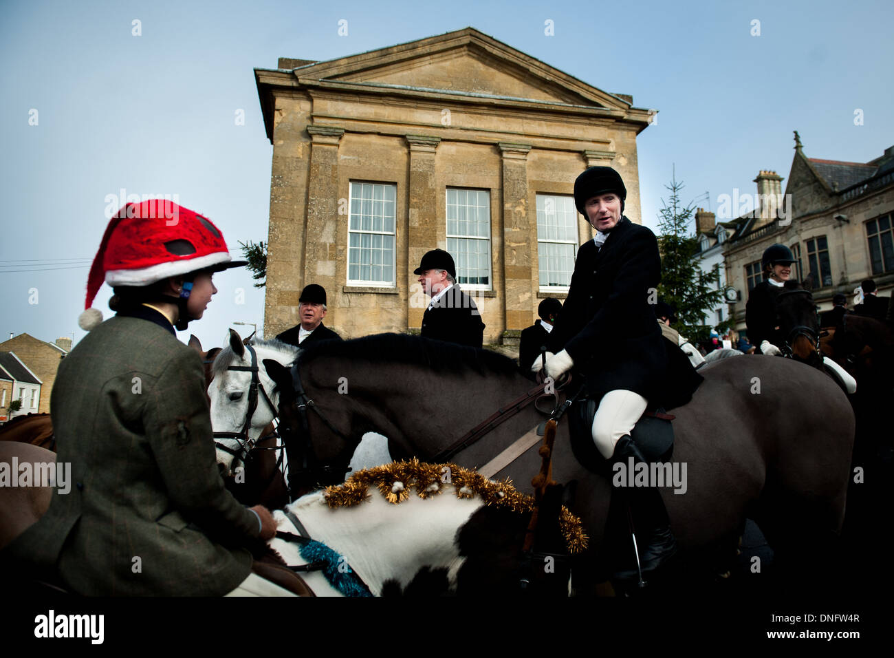 Riders, including child in santa hat, meet outside the Fox Hotel before Heythrop Hunt Boxing Day meet Stock Photo