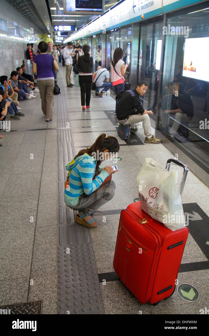 Beijing China,Chinese,Caishikou Subway Station,Line 4,passenger passengers rider riders,rider,Asian adult,adults,woman female women,platform,waiting,C Stock Photo