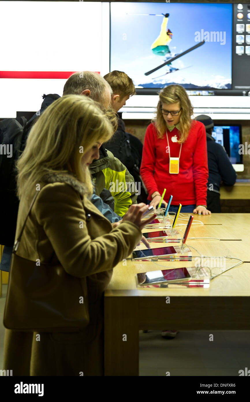 People trying out iPhones and iPads at the Apple Store Covent Garden, London, England Stock Photo
