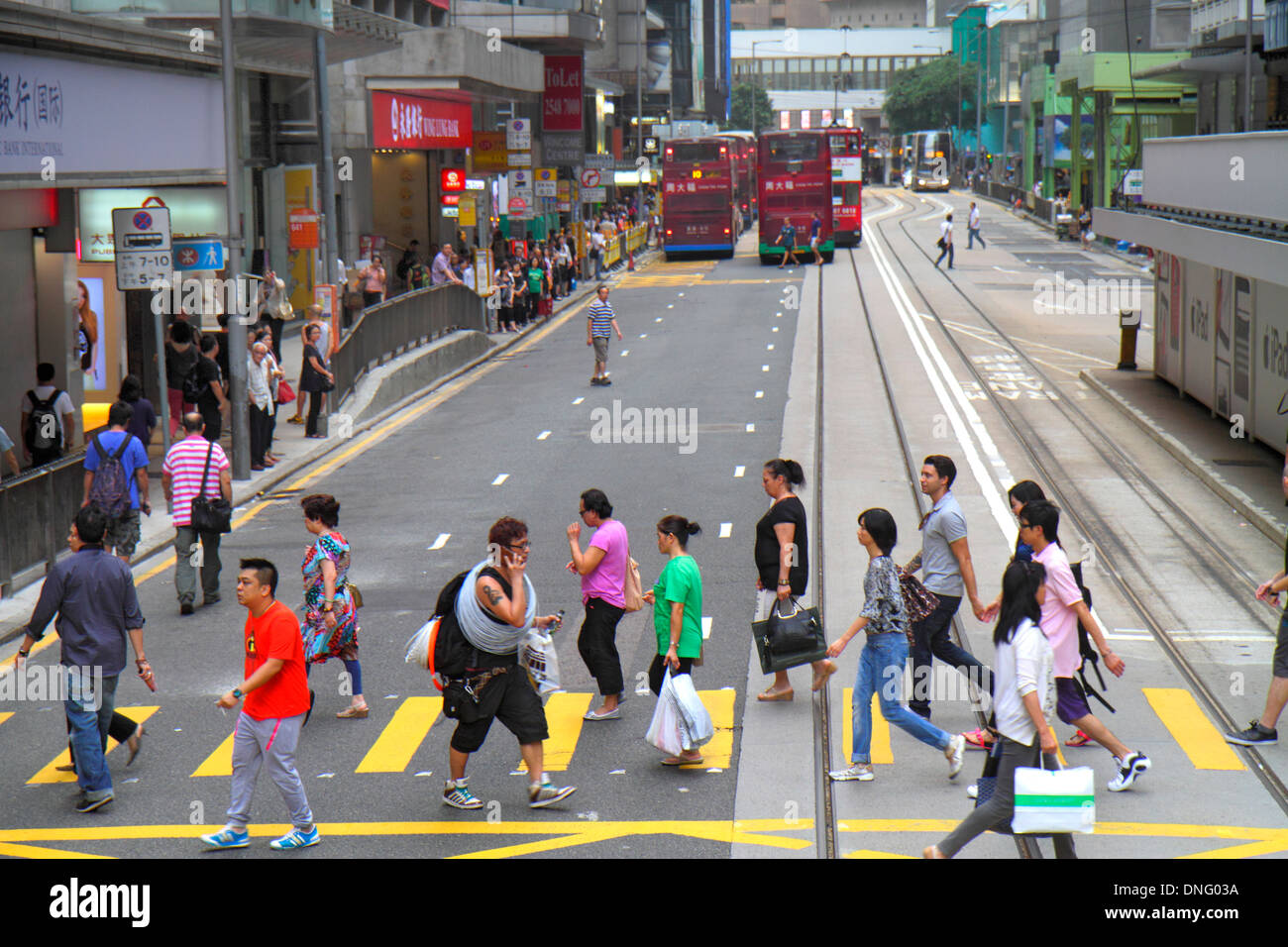 Hong Kong China,HK,Asia,Chinese,Oriental,Island,Central,Des Voeux Road Central,crossing street,tracks,Asian man men male,adult,adults,woman female wom Stock Photo