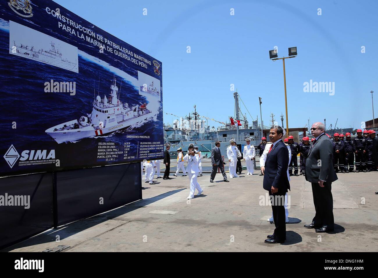 Callao, Peru. 26th Dec, 2013. Image provided by Peru's Presidency shows Peruvian President Ollanta Humala (L, front) observing an image of the ship that will be built by the Navy's Industrial Services (SIMA, for its acronym in Spanish), along Defense Minister, Pedro Cateriano (R, front), in Callao, Peru, on Dec. 26, 2013. Credit:  Peru's Presidency/Xinhua/Alamy Live News Stock Photo