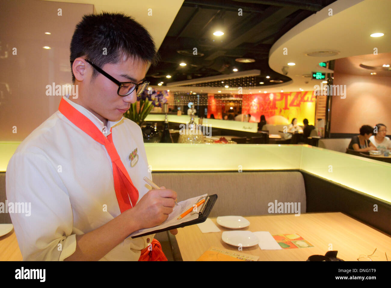 Beijing China,Chinese,The Malls at Oriental Plaza,Pizza Hut,restaurant restaurants food dining cafe cafes,cuisine,food,interior inside,Asian man men m Stock Photo