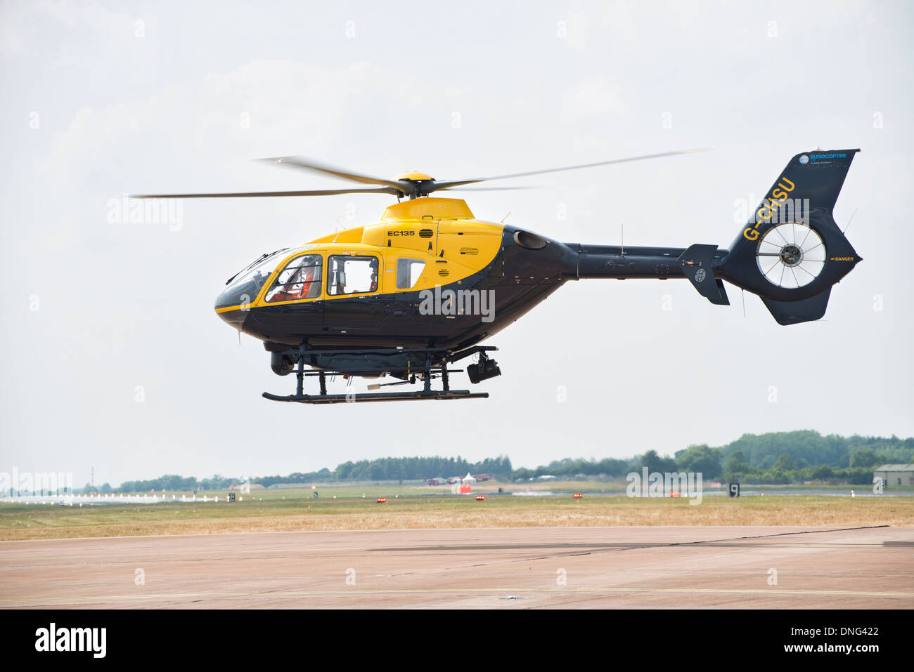 Eurocopter EC135 G-CHSU hover taxis at RAF Fairford as it arrives to take part in the 2013 RIAT Stock Photo