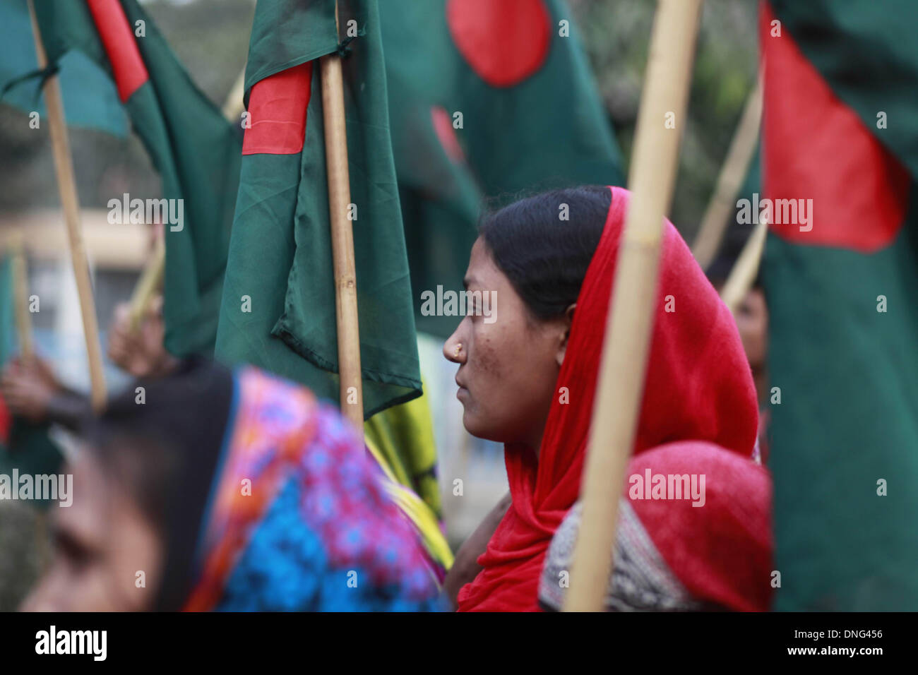 Dhaka, Bangladesh. 27th December 2013 -- A garment worker looks on during a protest following the arrest thirteen people charged over Tazreen factory fire by High Court where 112 worker had died. -- Tazreen garments worker & National Garmenta worker federation made protest rally in front of press club following the arrest thirteen people charged over Tazreen factory fire by High Court where 112 worker had died. Credit:  zakir hossain chowdhury zakir/Alamy Live News Stock Photo