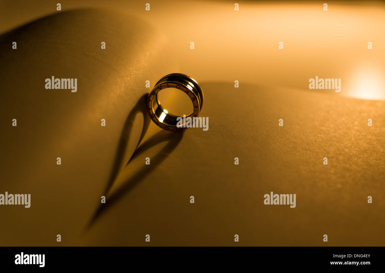 Engagement ring casting heart shaped shadow Stock Photo