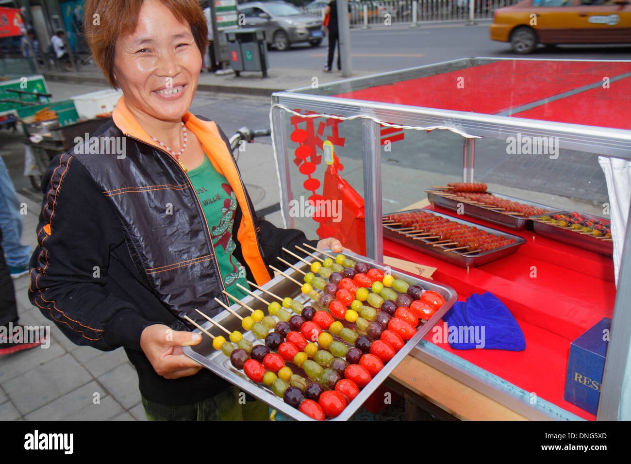 Beijing China,Chinese,Chaoyang District,Asian adult,adults,woman female women,street,food,vendor vendors stall stalls booth market marketplace,buyer b Stock Photo