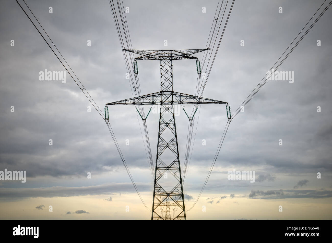 high voltage pylons silhouette cloudy sky background Stock Photo - Alamy