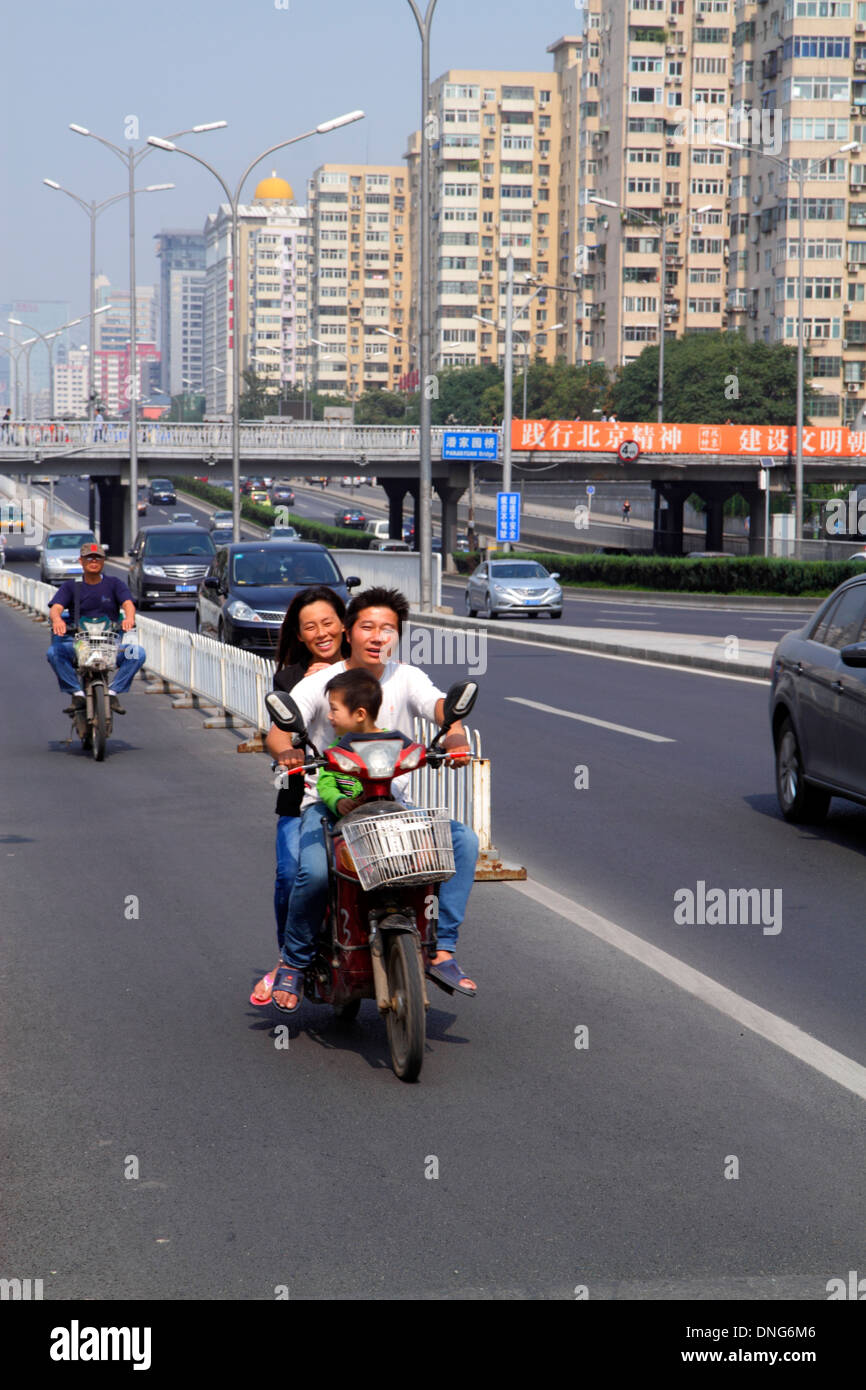 Beijing China,Chinese,Chaoyang District,Panjiayuan,moped,electric scooter,Asian man men male,father,woman female women,mother,boy boys male kids child Stock Photo