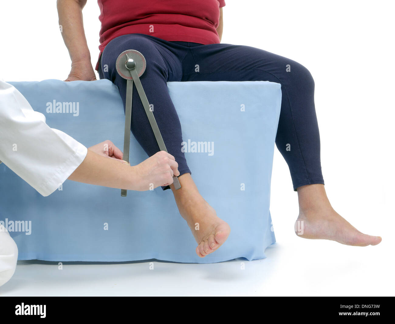 Physiotherapist measuring active range of motion of older patient's lower limb using manual goniometer Stock Photo