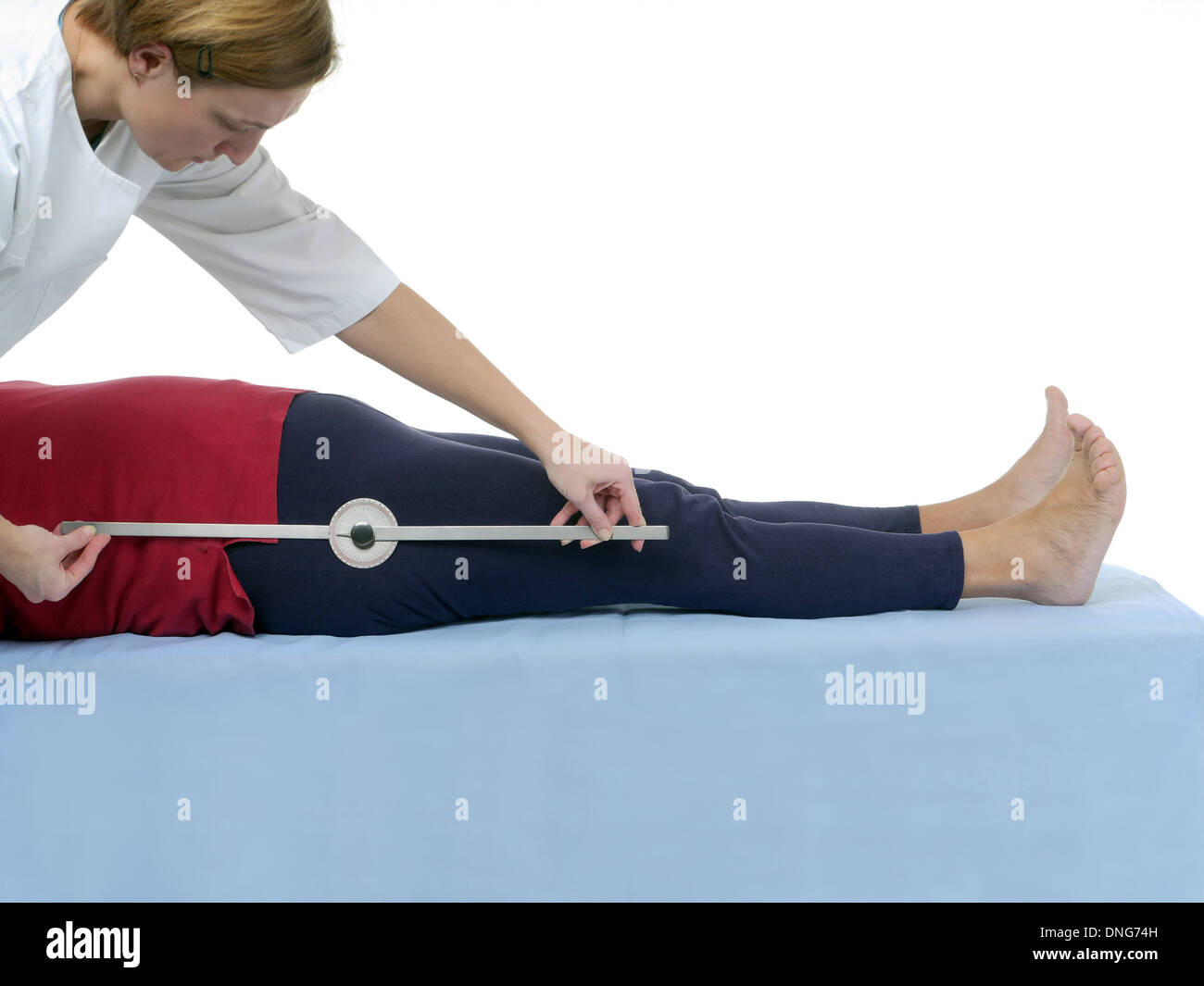 Physiotherapist measuring active range of motion of older patient's lower limb using manual goniometer Stock Photo