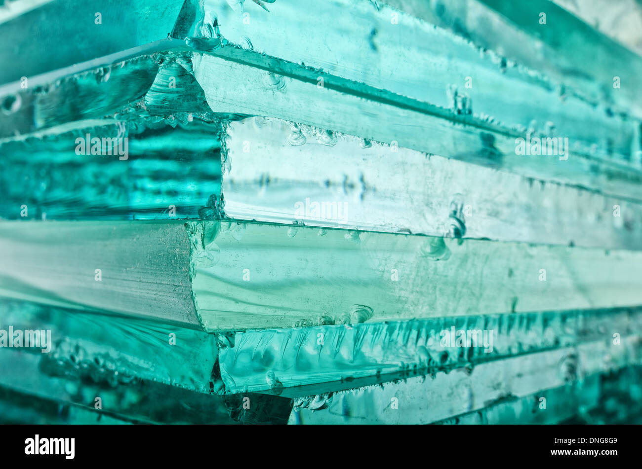 Sharp dangerous edge of plate glass internal reflection brings out green color and depth Stock