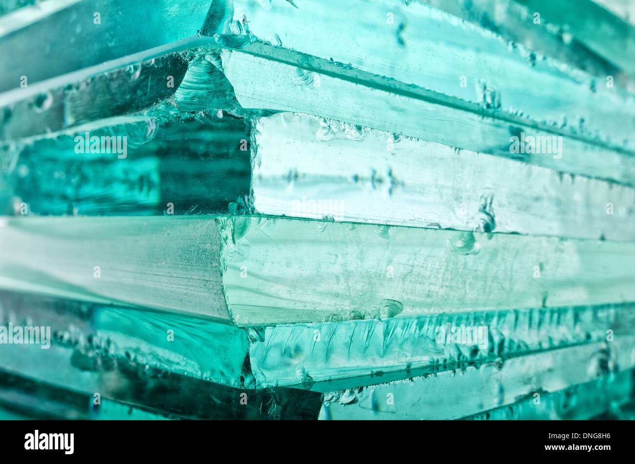 Sharp dangerous edge of plate glass internal reflection brings out green color and depth Stock