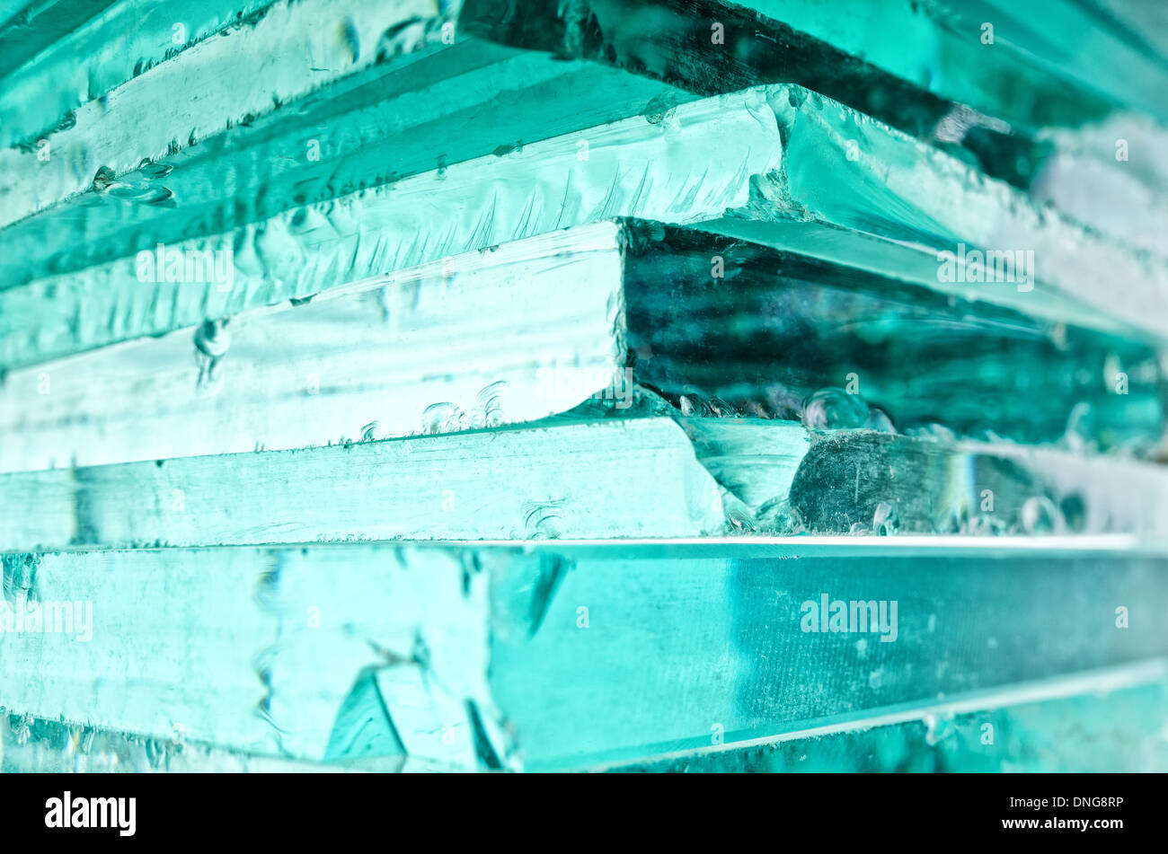 Sharp dangerous edge of plate glass internal reflection brings out green color and depth Stock