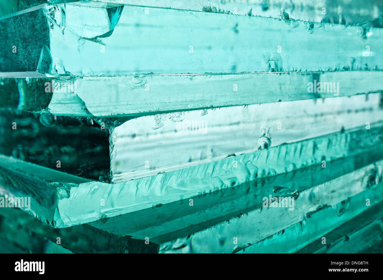 Sharp dangerous edge of plate glass internal reflection brings out green color and depth Stock