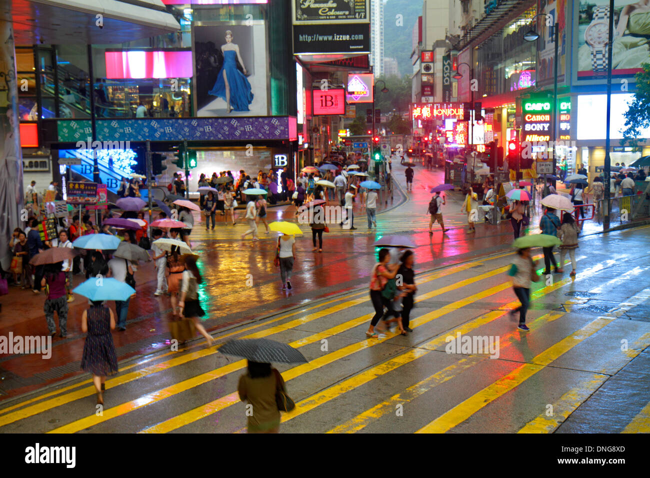 Hong Kong China,HK,Asia,Chinese,Oriental,Island,Causeway Bay,Yee Wo Street,East Point Road,weather,raining,signs,neon,umbrellas,night evening,shopping Stock Photo