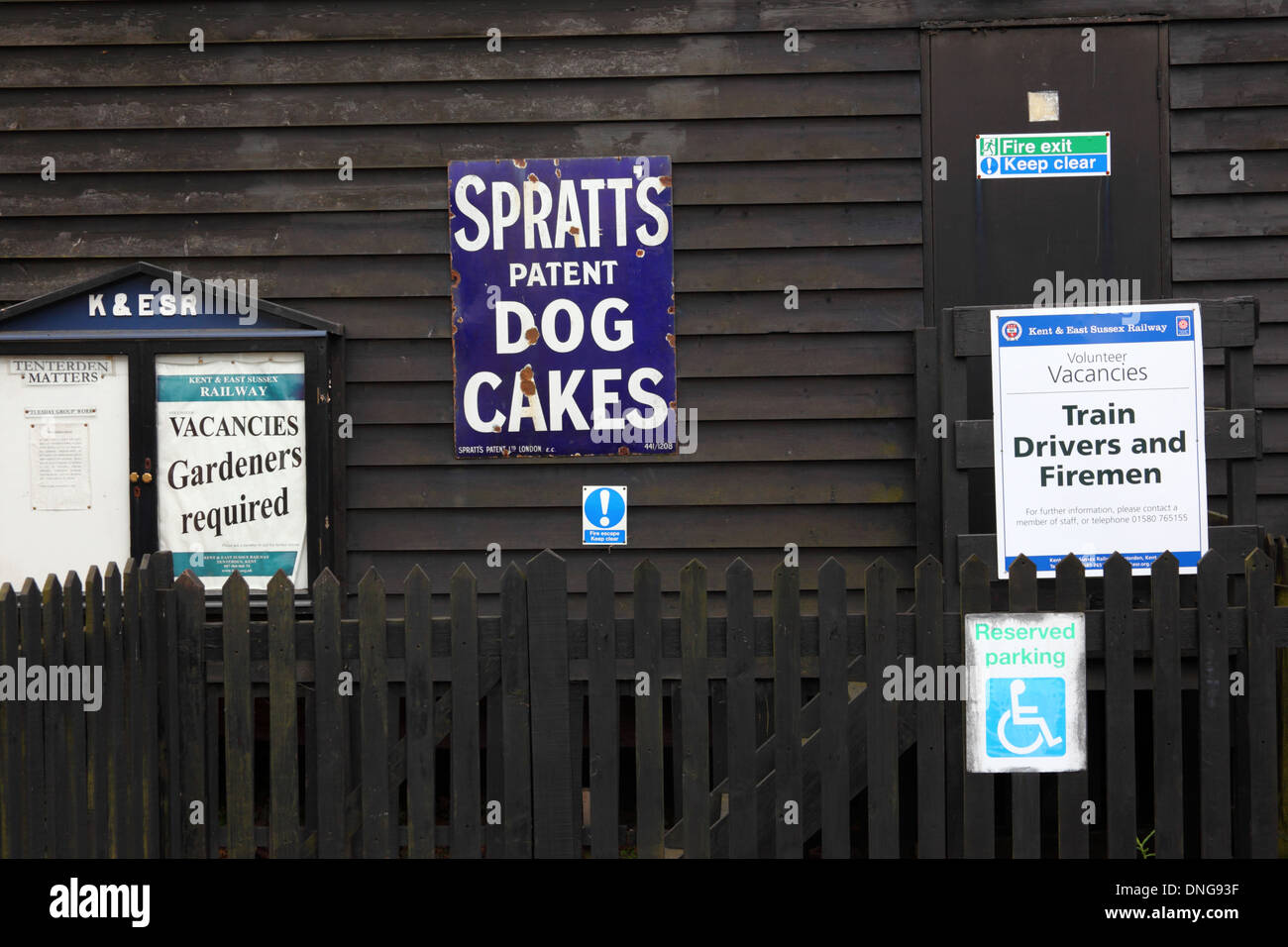 Old fashioned metal advert for Spratts Dog Cakes and job vacancies, Tenterden station, Kent & East Sussex Railway, England Stock Photo